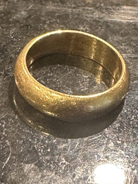 A recovered gold ring photographed after being cleaned of sand