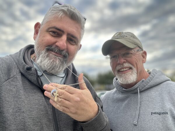 Dave the Ring Finder with a client holding a recovered necklace and ring